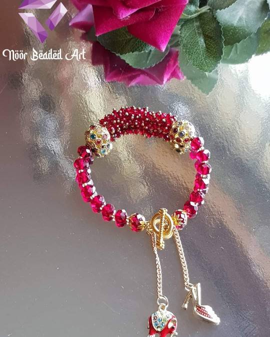 Red bangle bracelet with charms