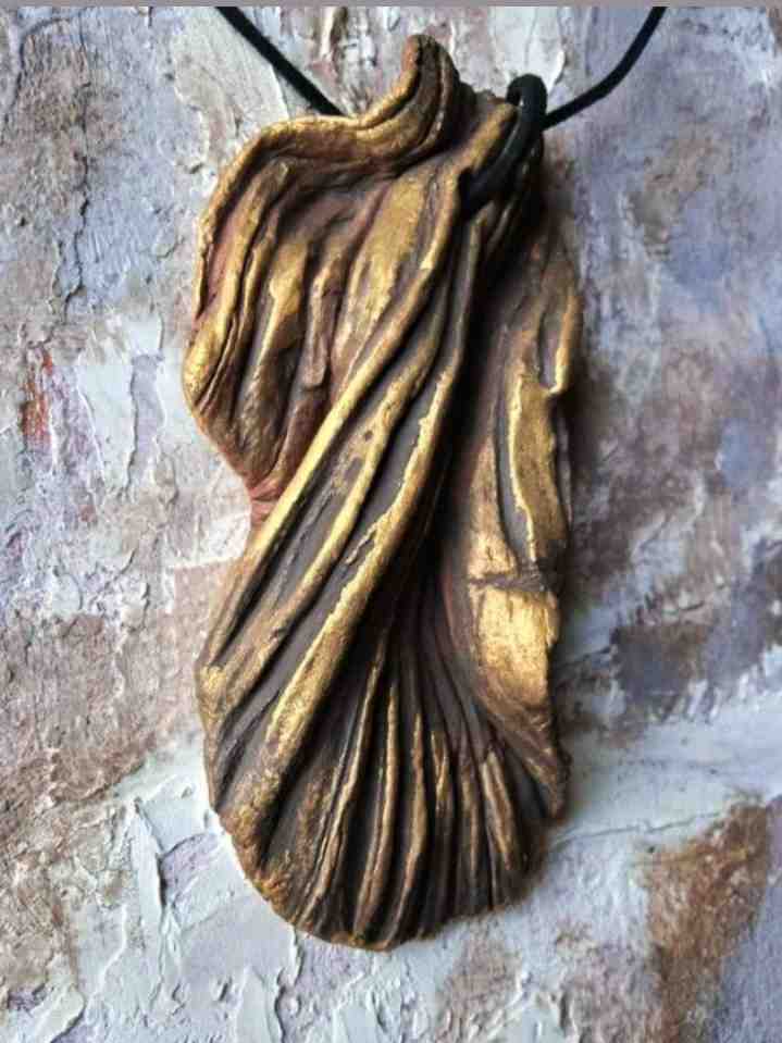 Hand sculpted pendant necklace.